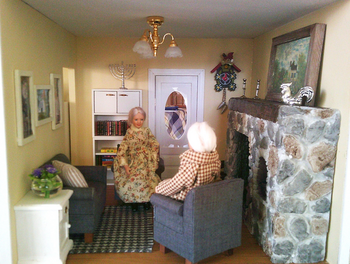 User Image Review showing a living room setup fit with an elder couple warming up by the fireplace.